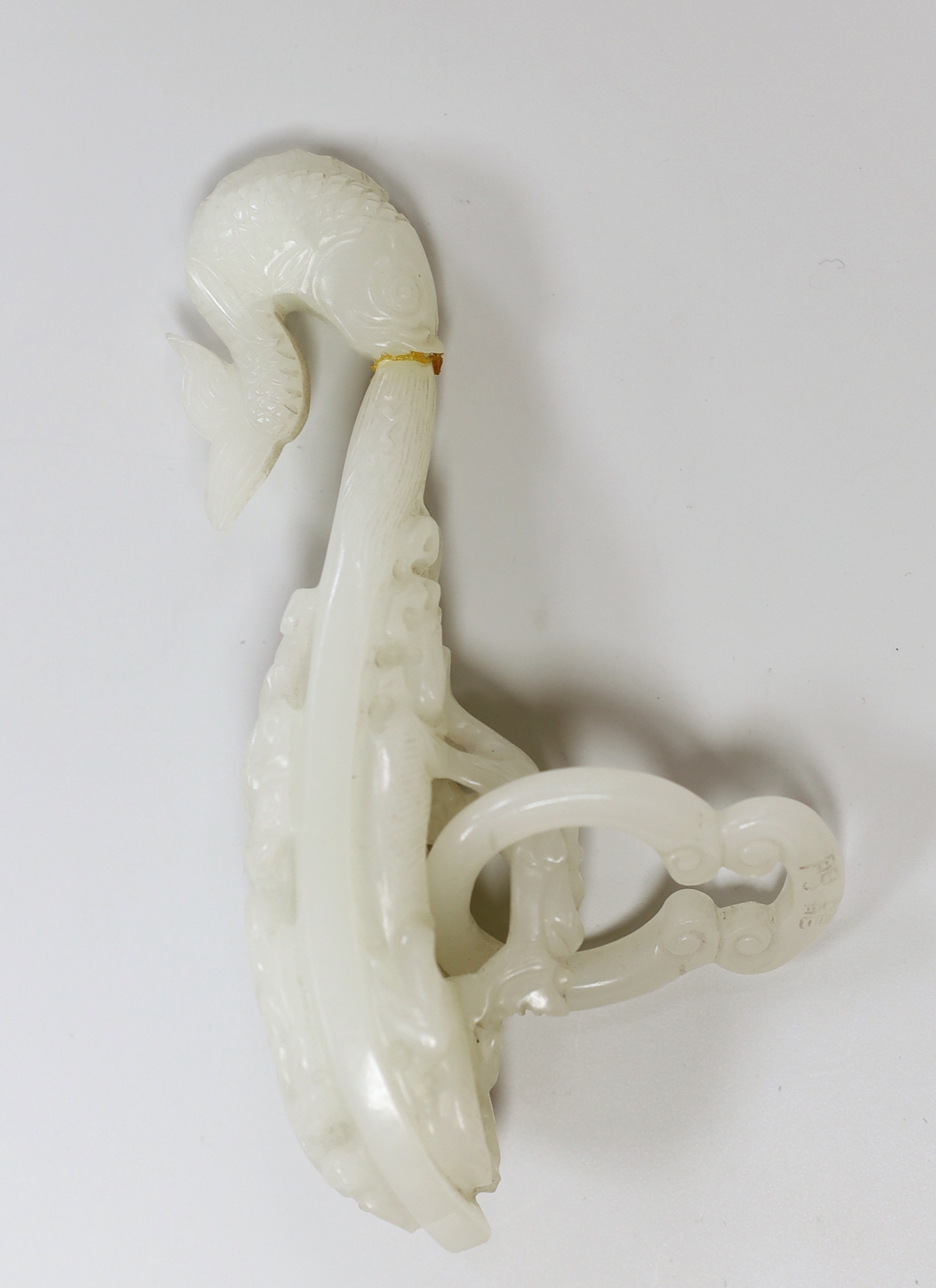 A Chinese white glass belt hook, apocryphal Qianlong marks (damaged)